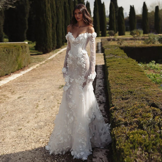 Graceful White Wedding Dress Features Floral Embellishments Long Sleeves With Deep V Neckline Flowing Fabric Creates Graceful