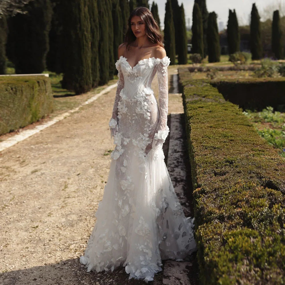 Graceful White Wedding Dress Features Floral Embellishments Long Sleeves With Deep V Neckline Flowing Fabric Creates Graceful