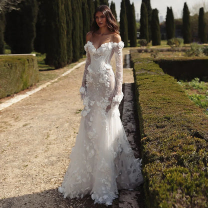 Graceful White Wedding Dress Features Floral Embellishments Long Sleeves With Deep V Neckline Flowing Fabric Creates Graceful