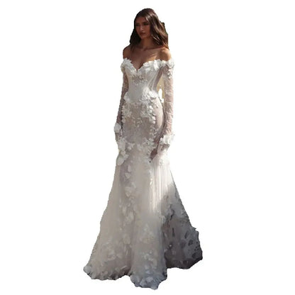 Graceful White Wedding Dress Features Floral Embellishments Long Sleeves With Deep V Neckline Flowing Fabric Creates Graceful